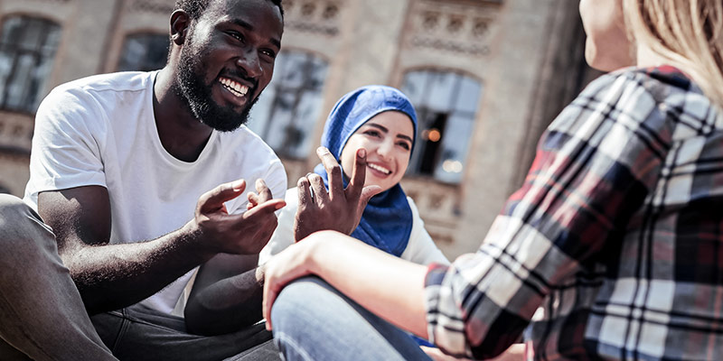 Students having a conversation in a foreign lanuage to learn speaking fluently