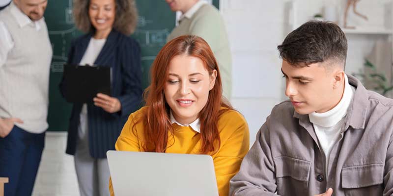 Woman and Man teaching themselves the new content while learning a language through digital materials - flipped classroom