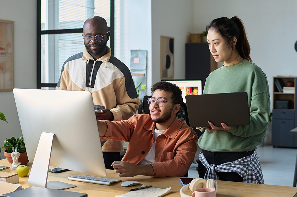 Group of people learning a language in front of a computer screen