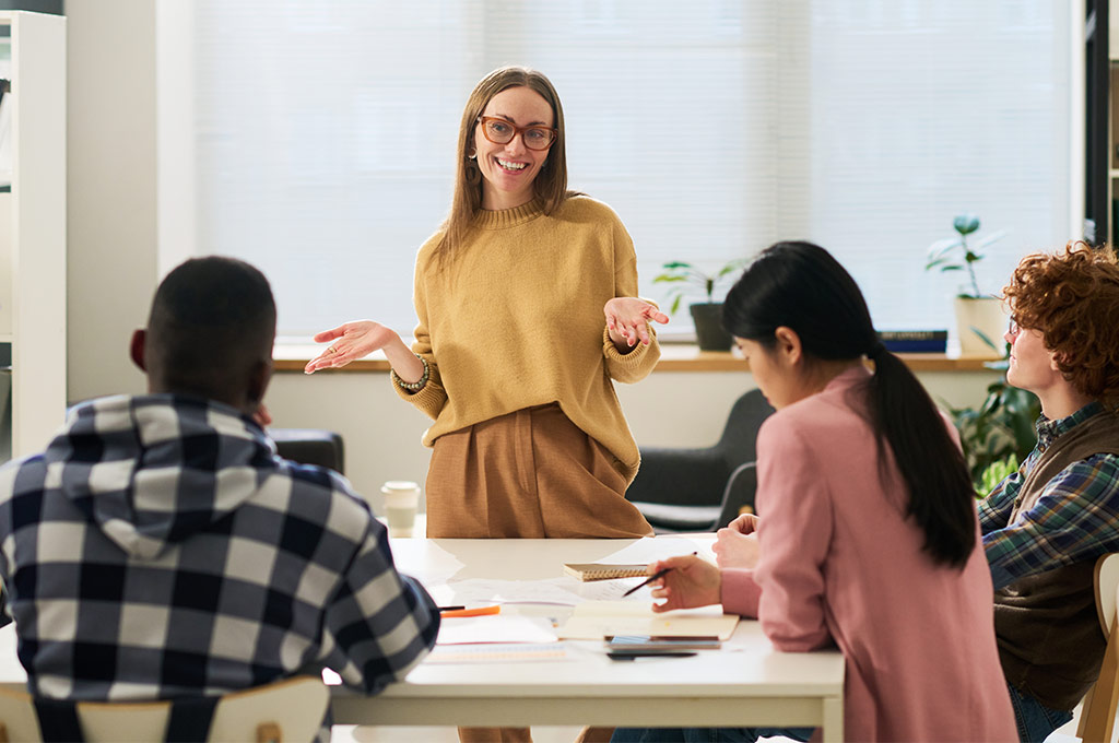 Female Teacher teaching a language in front of a class
