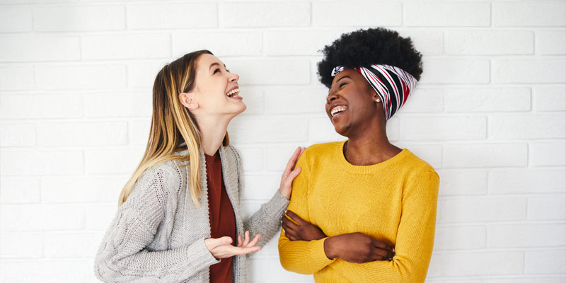 Two ladies chatting and laughing to each other