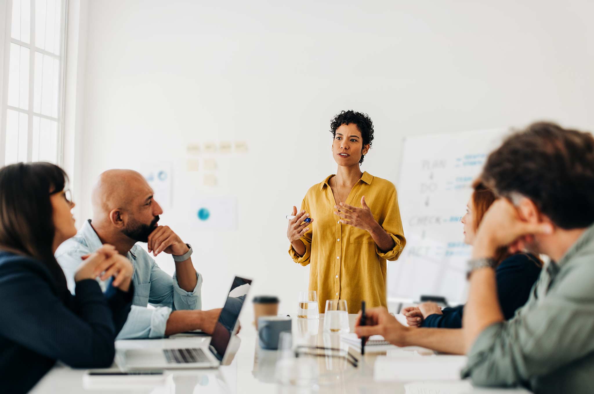 Language trainer leading an interactive discussion with students in a classroom