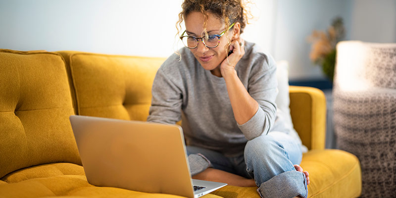 Woman taking an online language placement test from home on her laptop