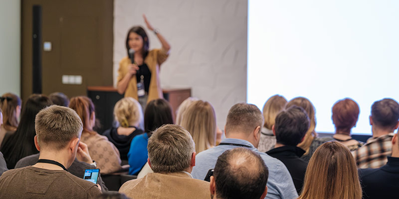 Woman confidently speaking in front of an audience