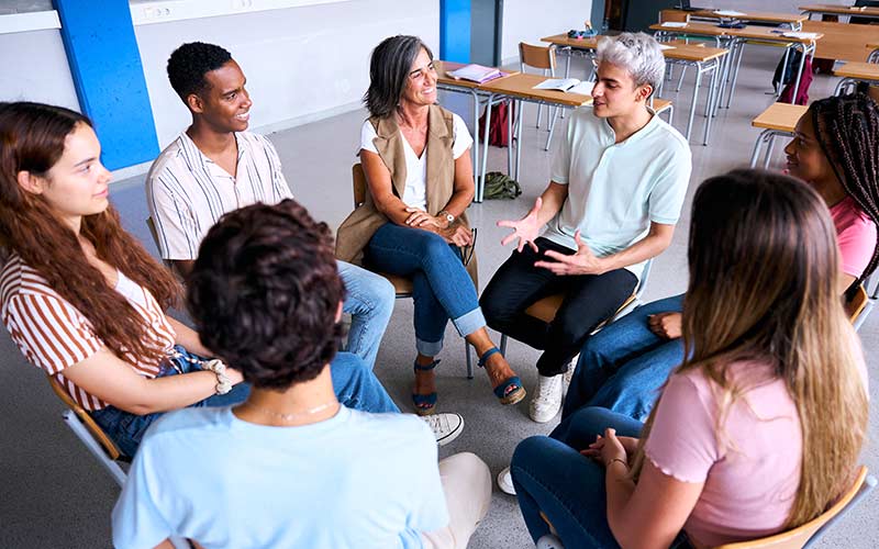 Learners actively participating in a group discussion, illustrating learner-centered language teaching and real-world communication practice