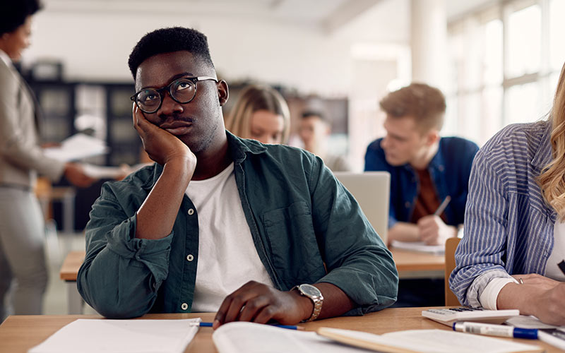 Bored language learner disengaged during an English class because the course level is too easy