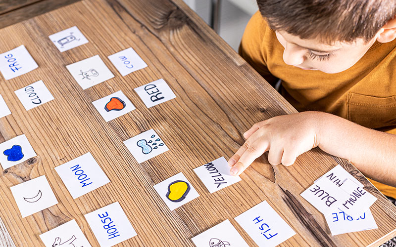 Young learner building language skills through interactive and play-based vocabulary activities