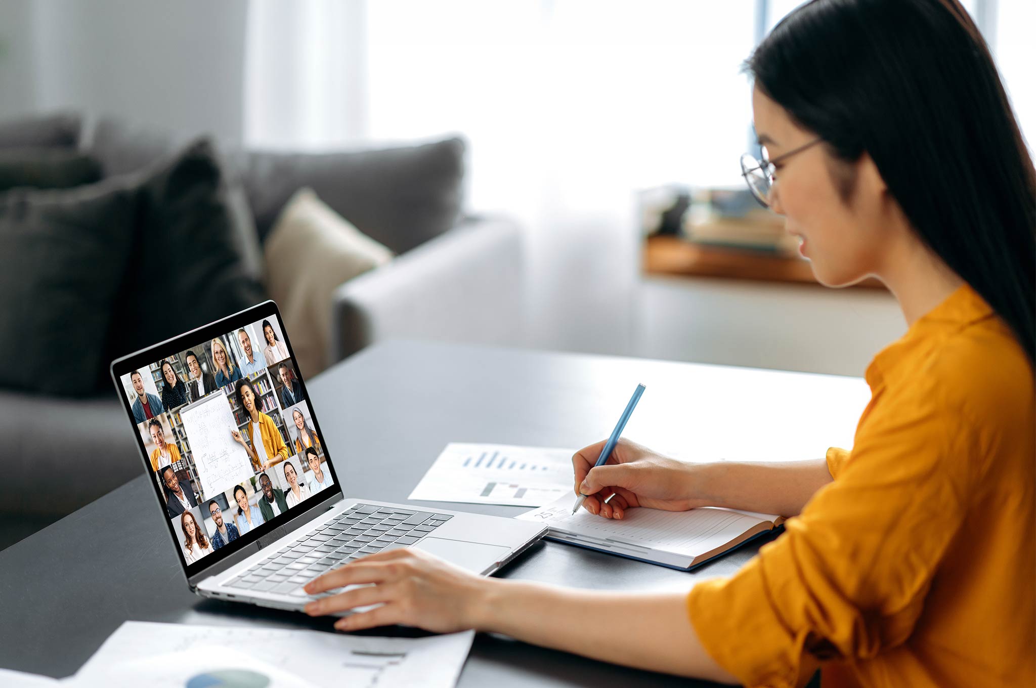 Learner actively participating in an interactive virtual language class with a trainer and other learners