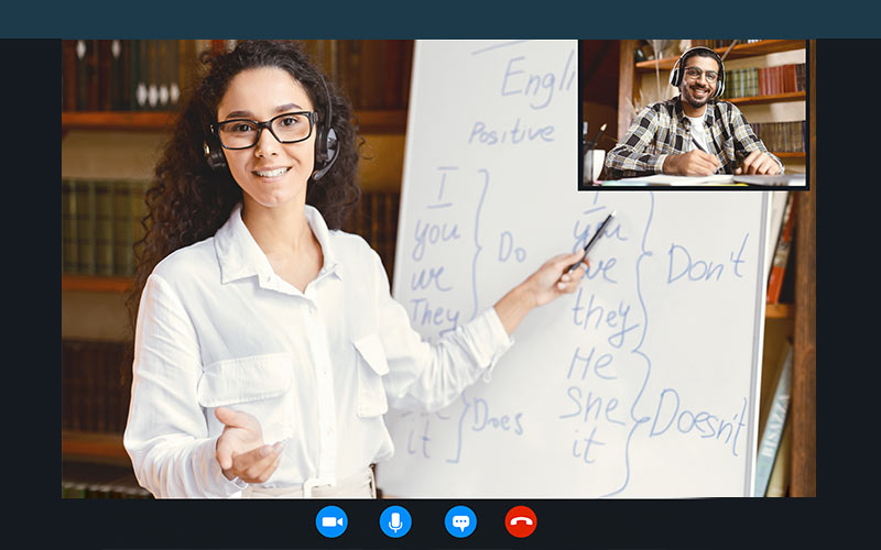 Online language trainer explaining English grammar to a learner during a live virtual lesson