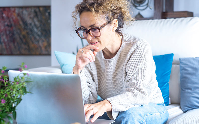 Learner comparing online language course options on a laptop before enrolling