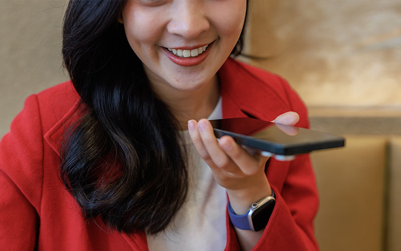 Learner practising speaking by recording herself on a smartphone