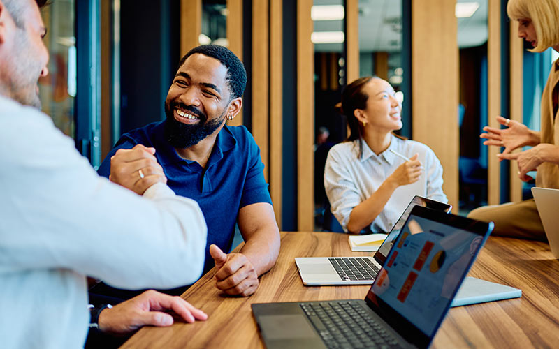 Employees confidently engaging in conversations with colleagues at work