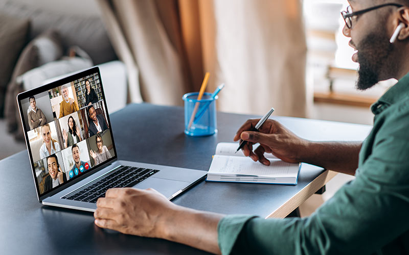 Person participating in a live virtual language class with a trainer and other learners