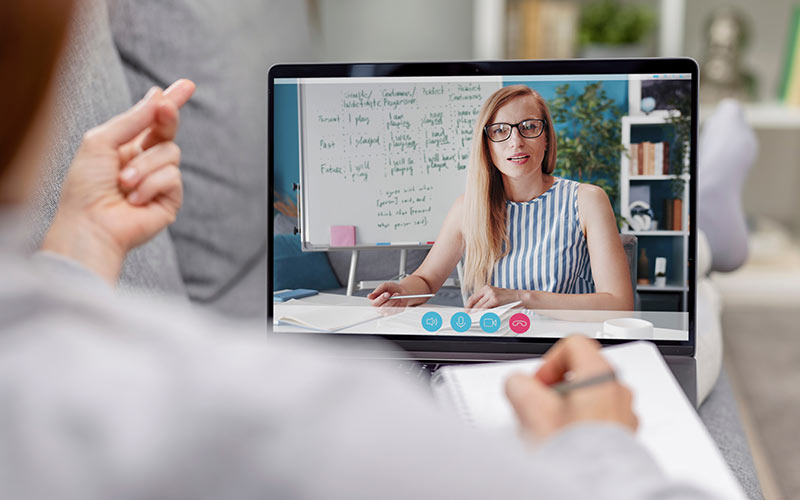 Learner receiving personalized support from a trainer during a one-to-one online language lesson