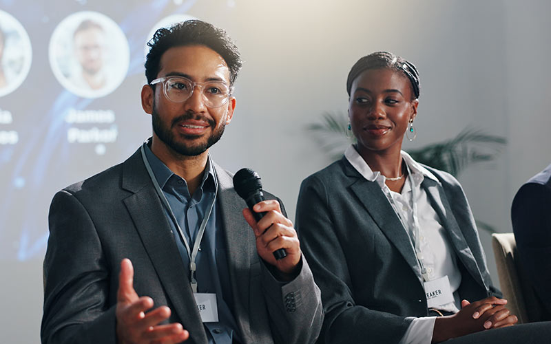Business leader speaking confidently during a professional panel discussion