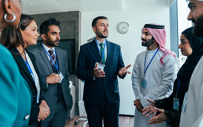 International professionals communicating and networking in a multicultural workplace