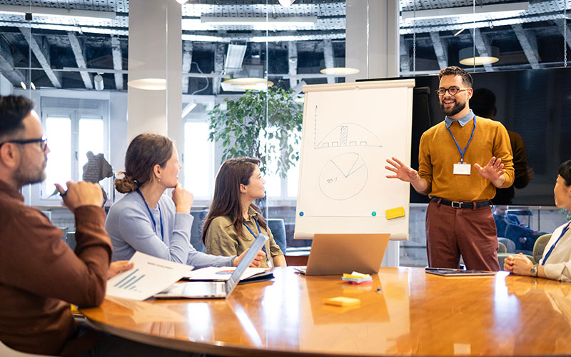Professional presenting ideas and communicating with colleagues during a workplace meeting