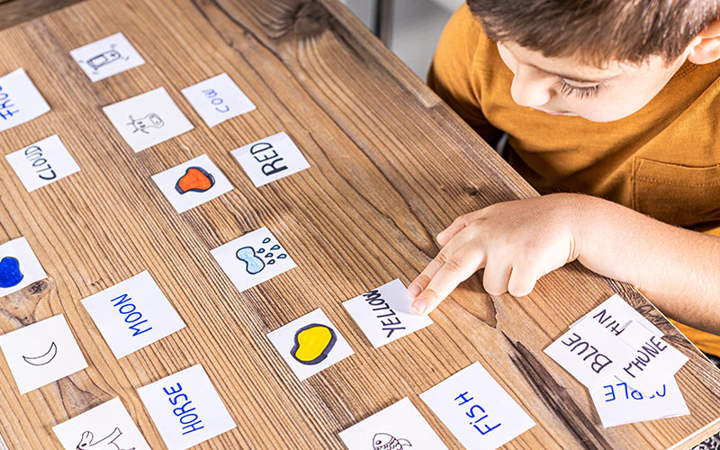 Child learning English vocabulary through an interactive word-matching game