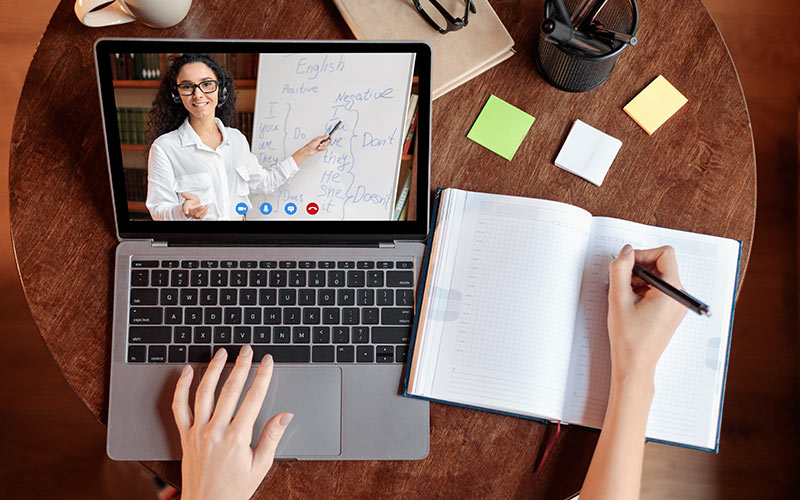 Professional participating in a live virtual corporate language training session with a trainer