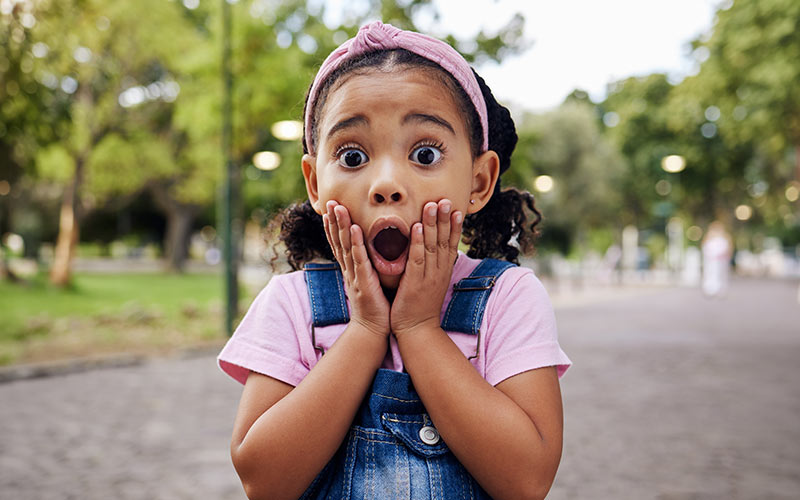 Child reacting with surprise while learning that mistakes are part of communication