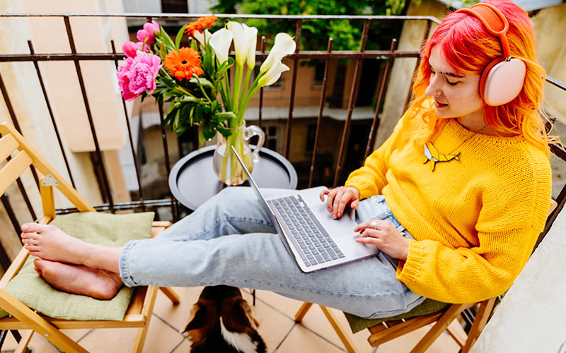 Learner using a laptop and headphones for flexible digital language learning from home