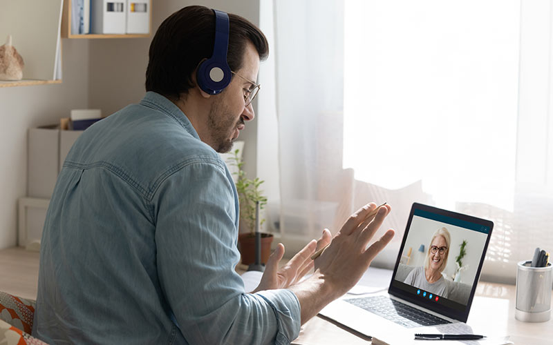 Learner speaking with a trainer by video call, combining digital access with personal guidance in online language learning